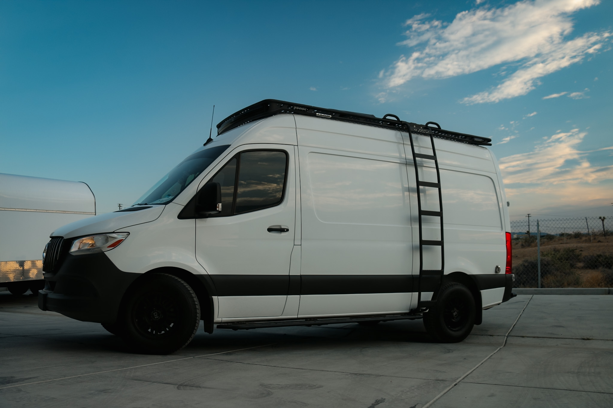 RDC CLB Rack Side view 144 Wheelbase Mercedes Sprinter Van with a Rugged Design Concepts Roof Rack, Baja LP Curved Light Bar Rack with Sprinter Side Ladder and Sprinter Side Steps