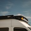 White 2025 Mercedes Sprinter Van High Roof Roof Rack with Baja Designs LP6 Pro LED lights and Fiamma F45s 350 Awning