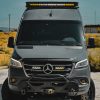 Silver Mercedes Sprinter Van with Rugged Design Concepts Sprinter Roof Rack housing Baja Designs Onx6 50 inch Arc light bar showcasing a Owl Outdoors Front Bumper