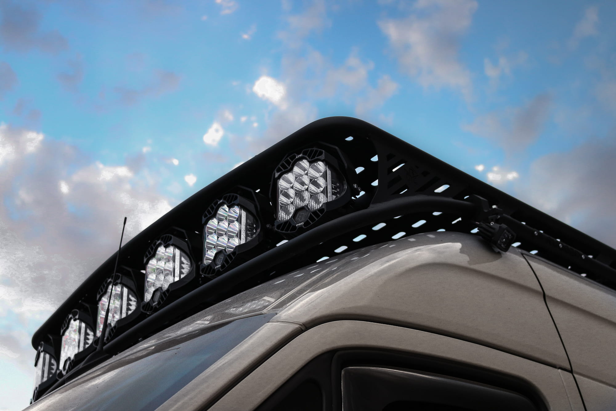 Rugged Design Concepts sprinter van with a Baja LP9 Roof rack paired with Baja designs LP9 Pro LED light Pods in the color, clear